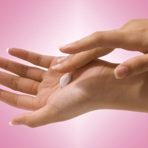 carpal tunnel syndrome massage Putting Hand Cream On Her Hands To Moisturize And Clean