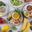 naturopathic doctor help food allergies selection in bowls with vegetables, fruits, nuts, brussels sprouts, brocolli, avocado, banana, sweet potatoe, ginger, pomegranate, peppers, almonds, corn, lemon, tumeric, mint, spinach, blueberry, garlic, sunflower seeds, oranges, citrus